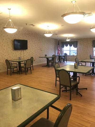 Dining area with tables and chairs in an activity room