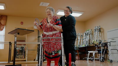 Resident enjoying activity with staff support