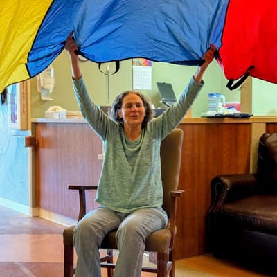 Resident engaging in a colorful activity in the common area