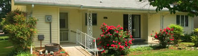 Exterior view of a nursing home entrance with flowers