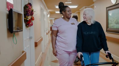 Staff member assisting a resident in the hallway