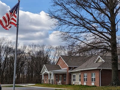 Exterior view of a nursing home facility with American flag