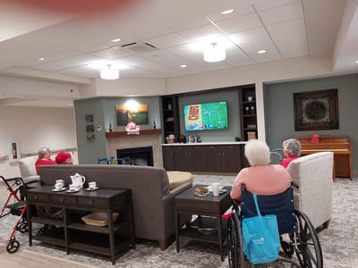Residents enjoying TV time in a cozy lounge area