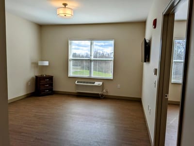 Empty resident room with a window and furniture