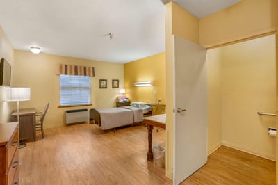Cozy resident room with a bed and a desk