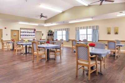 Bright dining room with wooden tables and flowers