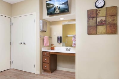 Interior of a resident room with a bathroom sink area