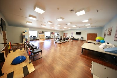 Rehabilitation room with exercise equipment and therapy tools
