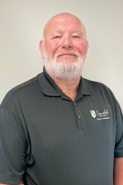 Smiling staff member in a polo shirt