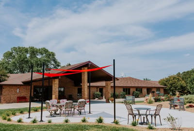 Outdoor seating area in front of a nursing home