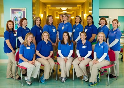Group of staff members in a brightly lit hallway
