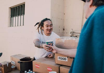 Staff serving food at an outdoor event