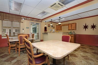 Well-lit dining area with tables and chairs