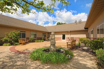Outdoor courtyard with a fountain and seating