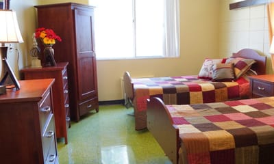Cozy resident room with two beds and furniture