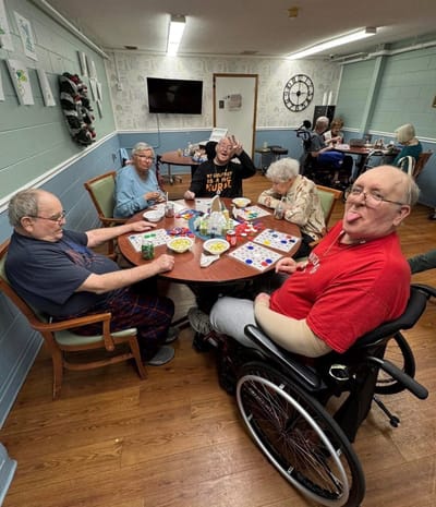 Residents enjoying bingo in a communal activity room