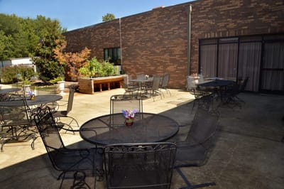 Outdoor patio area with tables and plants
