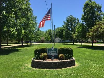 Flag and sign in a well-maintained garden area