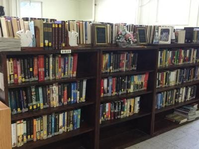 Bookshelves filled with various books in a library
