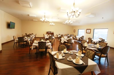 Dining room setup with neatly arranged tables and chairs