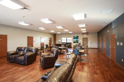 Spacious common area with seating and tables
