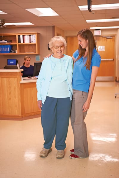 Staff member assisting a resident in a communal area