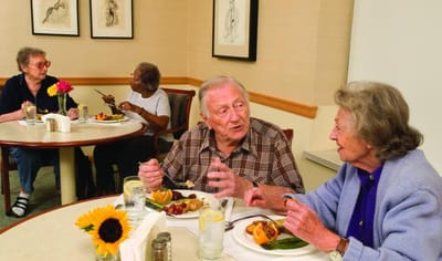 Residents enjoying a meal together in the dining room