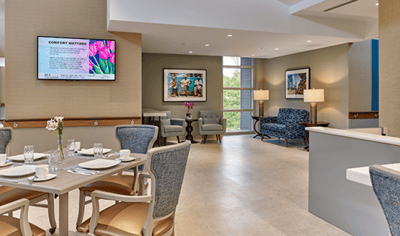 Dining area with elegant table settings and art on walls
