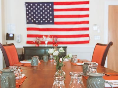 Dining room set up with American flag in the background