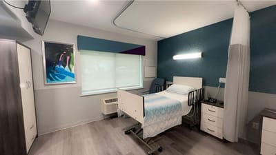 A private resident room with a hospital bed and furnishings