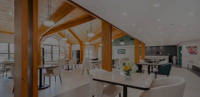 Bright dining area with wooden beams and tables