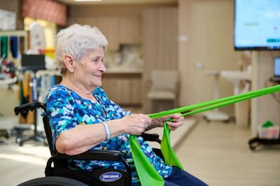 Senior resident participating in a therapy exercise class