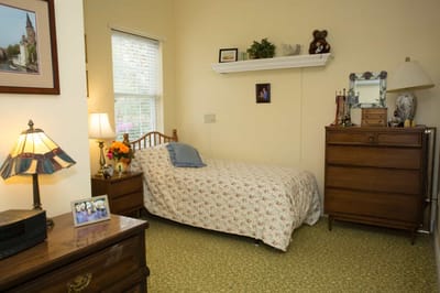 Cozy private resident room with floral bedding