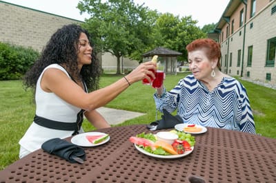 Residents enjoying a meal together outdoors