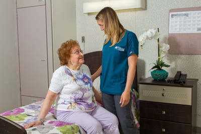 Staff member interacting with a resident in a cozy room
