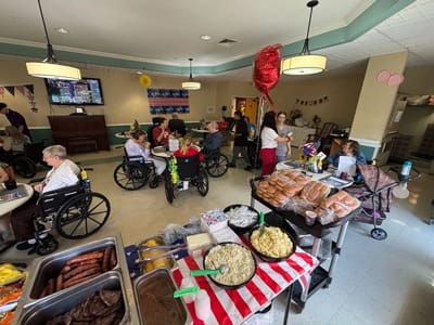 Residents participating in a festive indoor activity with food