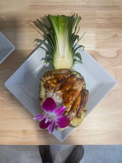 A gourmet meal presented in a pineapple