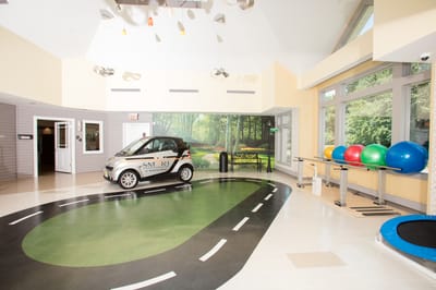 Interior activity space with car and exercise equipment