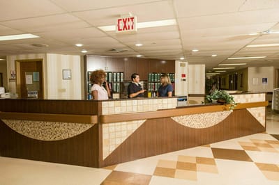 Staff members interacting at the facility reception area