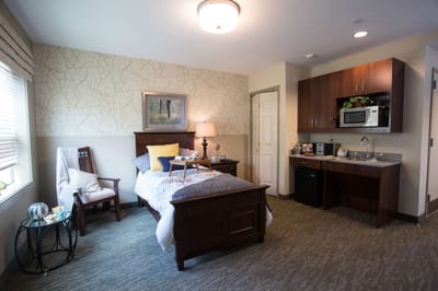 Cozy private room with a bed and kitchenette