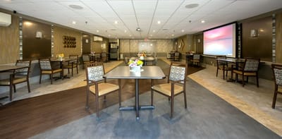 Bright and welcoming common area with tables and chairs