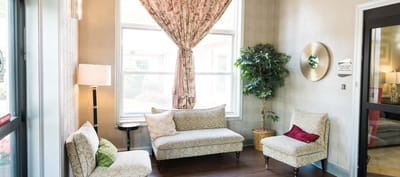 Cozy lounge area with floral curtains and seating