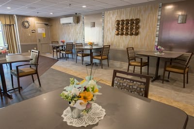 Empty dining room with tables and floral arrangements