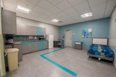 Bright interior of a resident room with kitchenette