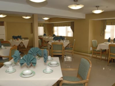 Dining area with neatly arranged tables and settings