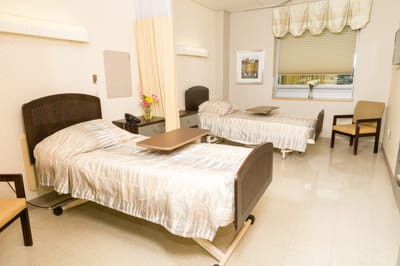 A shared resident room with two beds and a window