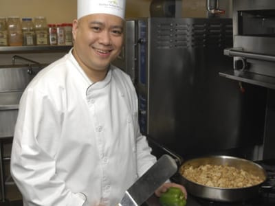 Chef preparing food in the kitchen of the facility