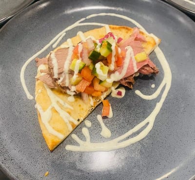 Close-up of a tortilla wrap with various toppings