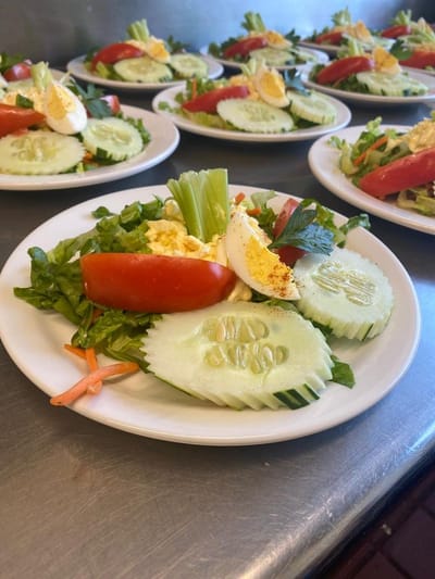 Freshly prepared salads plated for dining service
