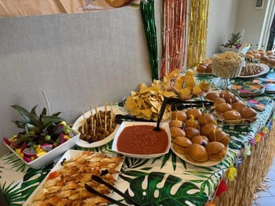 Buffet table with various food items for a celebration